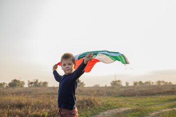 Young boy holding flag of Mexico. "September 16. Independence Day of Mexico".