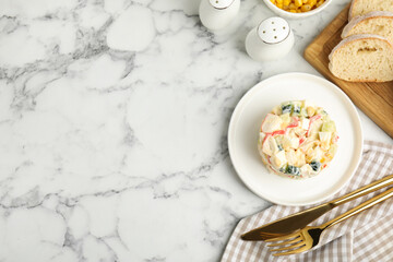 Delicious salad with fresh crab sticks served on marble table, flat lay. Space for text
