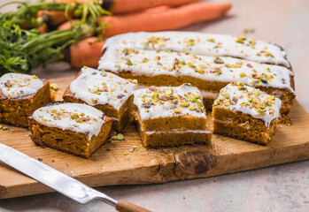 A  carrot cake with fresh carrot on concrete  background