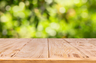 wooden empty table with blurred green garden