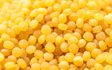 Dry toasted pasta ptitim (petit plomb or Israeli couscous) close-up.