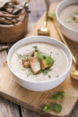 Homemade mushroom cream soup with sliced dry mushrooms. Top view