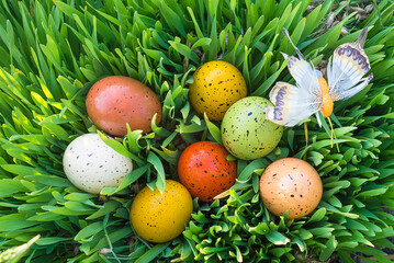 Easter holiday composition. Easter eggs on green grass top view, close up