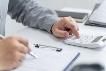 .Financial inspector calculating a numbers in office room.