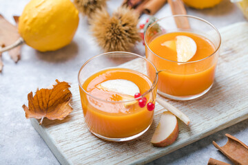 hot pumpkin punch or sangria in a glass with apple. Halloween and Thanksgiving beverage. Traditional autumn, winter drinks and cocktails