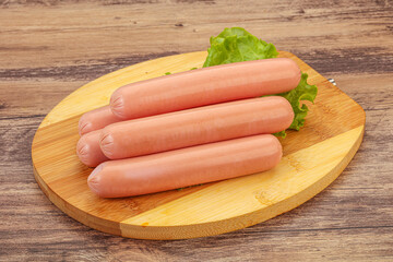 Tasty meat sausages over board