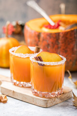 Pumpkin punch or sangria in a big pumpkin. Halloween and Thanksgiving. Traditional autumn, winter drinks and cocktails