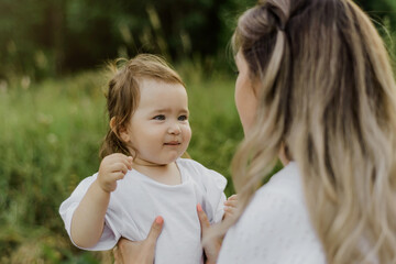 mother and little daughter together have fun playing and hugging, the concept of happy motherhood and childhood, love for the child