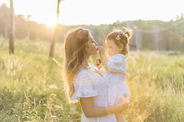 mother and little daughter together have fun playing and hugging, the concept of happy motherhood...