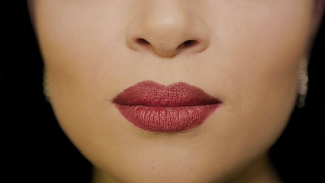 The girl makes an air kiss with her lips