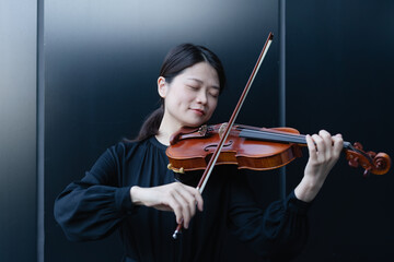 Asian woman playing the violin