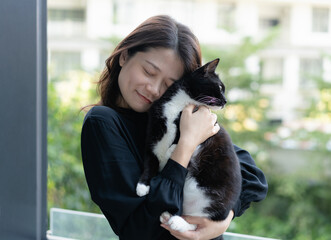 happy woman hugging her cat