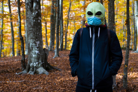 alien with surgical mask in the woods