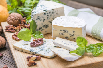 Fourme d'ambert blue cheese  and walnuts. Wooden background. Top view