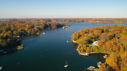 Aerial view of colorful sailboat moorings, docks,   and bright golden foliage on Weems Creek, in historic downtown Annapolis Maryland on a fall day - obrazy, fototapety, plakaty