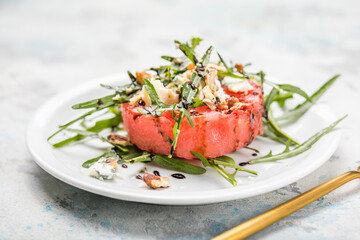 summer watermelon salad with blue cheese , arugula on light background. Healthy food, clean eating