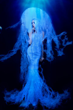 Beautiful blue female portrait as jellyfish underwater