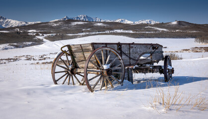 Fototapeta na wymiar A heritage wooden horse drawn wagon on the Alberta prairies near Waterton National Park,