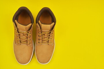 New mens leather brown waterproof hiking winter autumn boots on yellow background