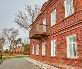old red brick building with wooden carved balcony