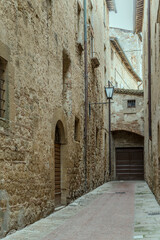 Fototapeta na wymiar old buildings on narrow lane at historical little town, Pienza, Siena, Italy