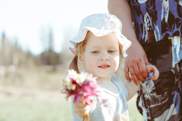 a girl holds a flower in her hands