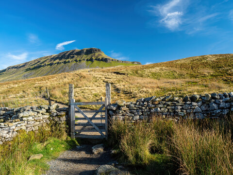 A stone path with a gate takes the hiker up to the mountain of Pen-y-ghent in the Yorkshire Dales National Park. At 2,277 feet, the mountain is one of the 'Three Peaks of Yorkshire'.