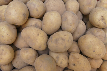 Fresh potatoes on the counter top view close-up.