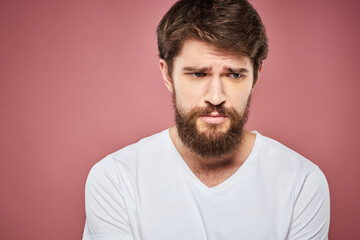 Obraz premium Man in white t-shirt emotions lifestyle facial expression cropped view pink background.