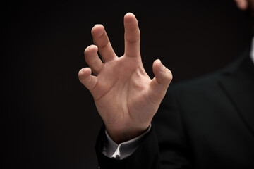 Man's hand gesture holding object