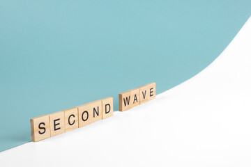 Second wave of the coronavirus pandemic written with wooden letters.