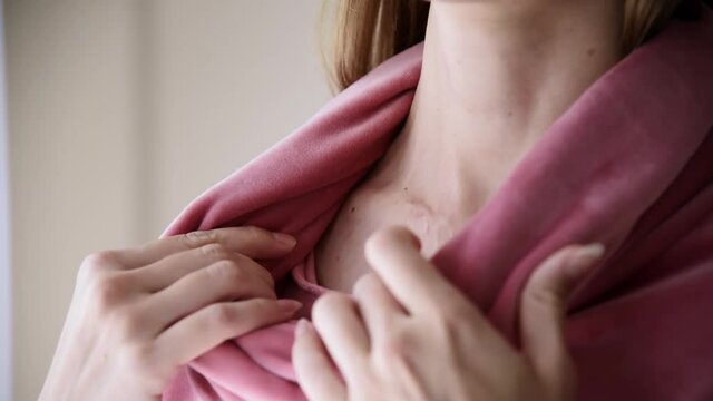 Woman showing a surgery scar on her neck 