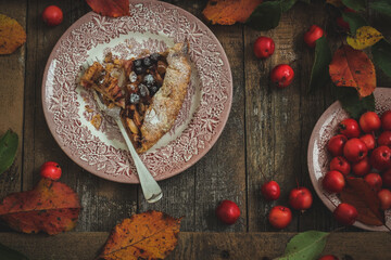 A slice of apple galette in autumn styling, flat lay