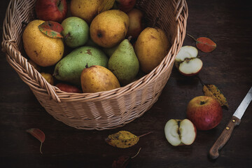 Yellow and green pears and some apples on a rustic table