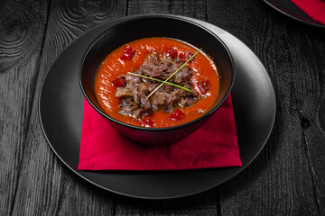 Tomato soup with beef pieces. Gazpacho. Festive table with delicious food.