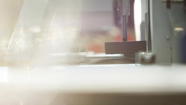 Buzzsaw cutting automatically metal profile in big warehouse/workshop 4k PRORES Footage