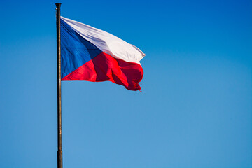 Prague, Czech republic - September 19, 2020. Flag of Czechia flying in the wind on the blue sky