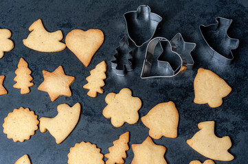 Fresh delicious Cookies for Christmas displayed on a slate plate, with forms for making cookies.