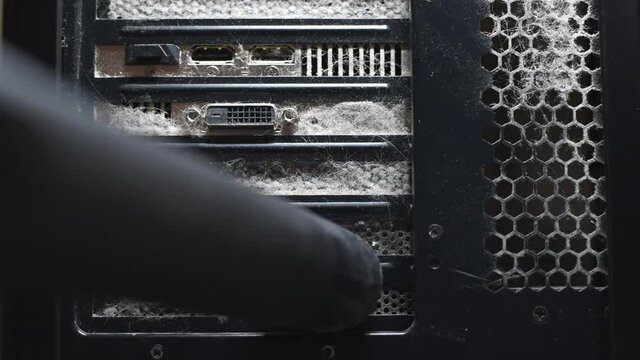 Close up of cleaning thick dust from computer ports with vacuum cleaner.