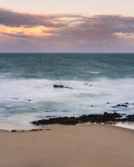 Waves in Santa cruz, Portugal beach at sunset, long exposure calm and relaxing landscape