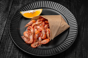 Small shrimps boiled with salt and spices. Beer snack. Festive table with delicious food.