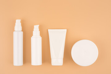 Minimalistic still life with a set of cosmetic products for skin care on bright beige background