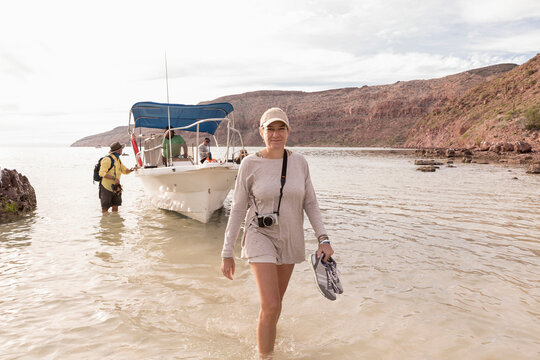 Woman walking to shore from power boat, Sea of Cortes