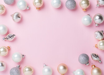 white and gold christmas balls on pink background