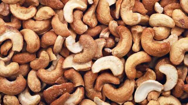 Rotating cashew nuts peeled full. View from above.	