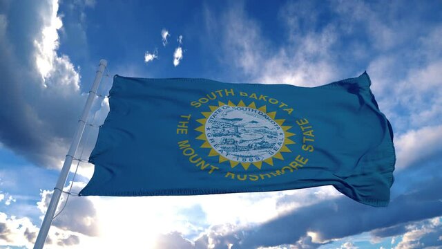 South Dakota flag on a flagpole waving in the wind, blue sky background. 4K