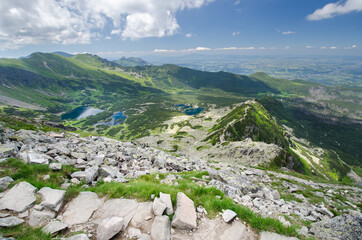 View of Green Gąsienicowa Valley (Dolina Zielona Gąsienicowa) from Mount Kościelec during clear weather, with Mt Kasprowy Wierch and Giewont in the background, Tatra Mountains, Poland - obrazy, fototapety, plakaty