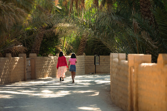 Photo of two girls walking in Al Ain Oasis
