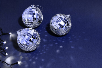 silver disco ball on blue background, greeting card wallpaper template with empty space for text

