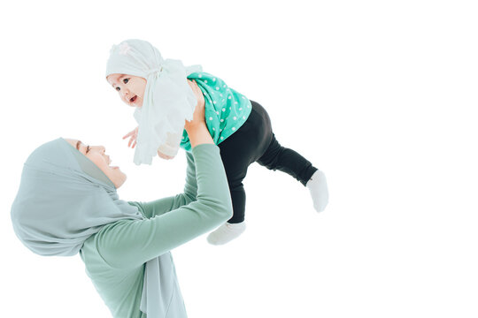 Muslim Family Or Islam Mother Rise Play With Baby Isolated On White Background.